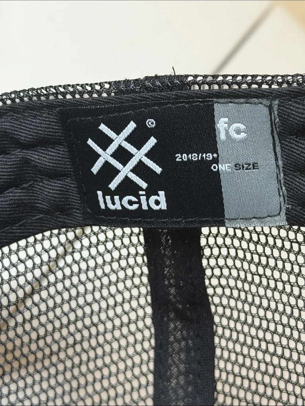 Lucid FC Black Trucker Hat with Silver Embroidered Geometric Logo, Rihanna style
